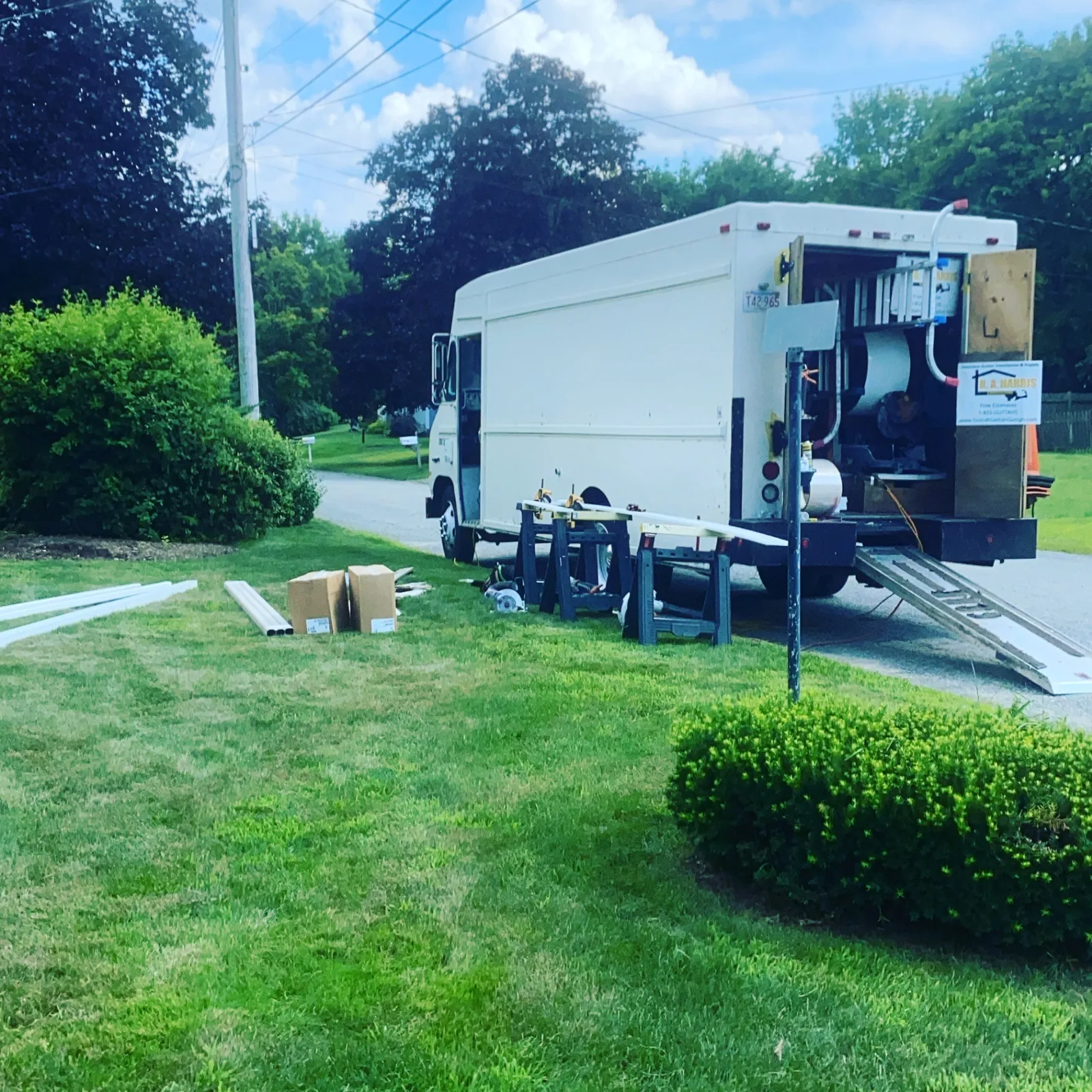 B.A. Harris service truck set up on-site for gutter fabrication in a neighborhood