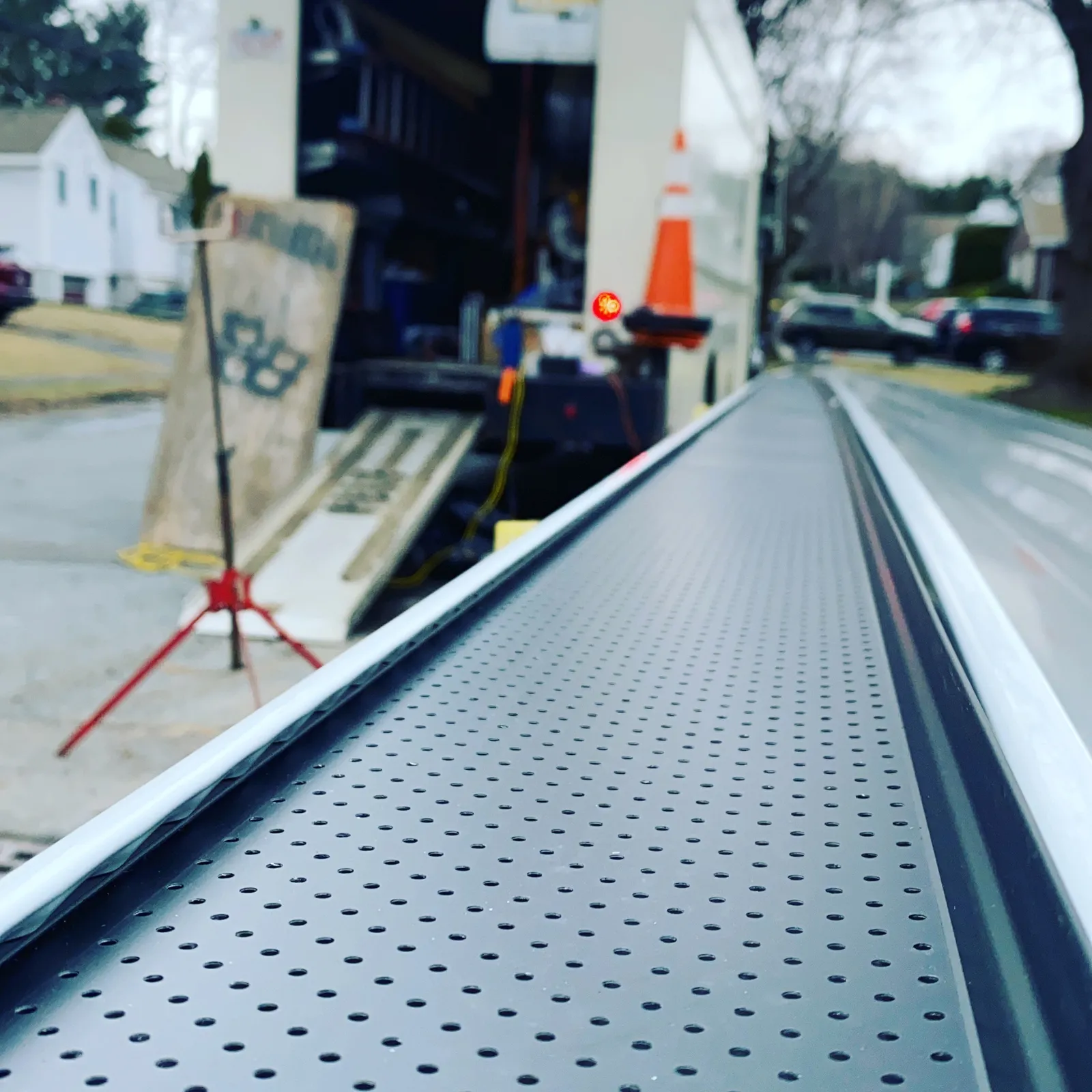 Close-up perspective of metal gutter guard protection installed along the roof edge